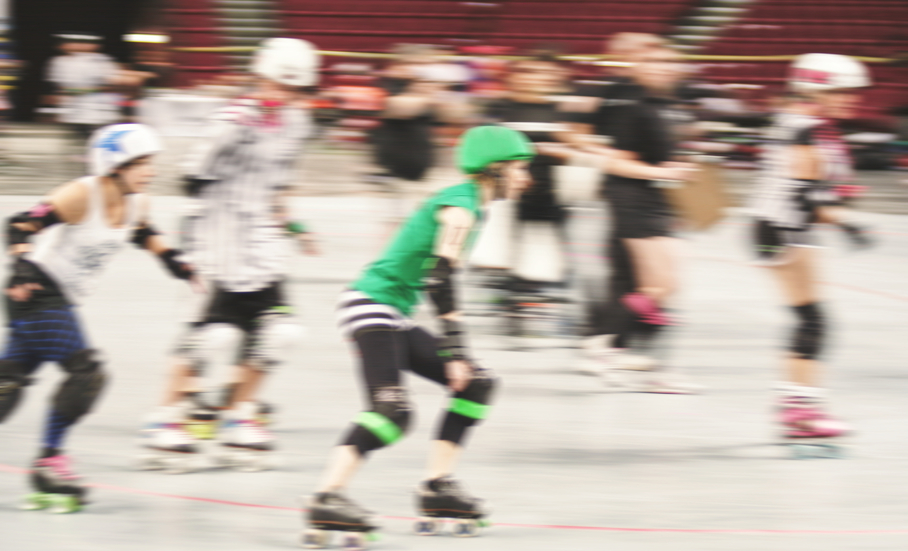 some women participating in roller derby with a motion blur