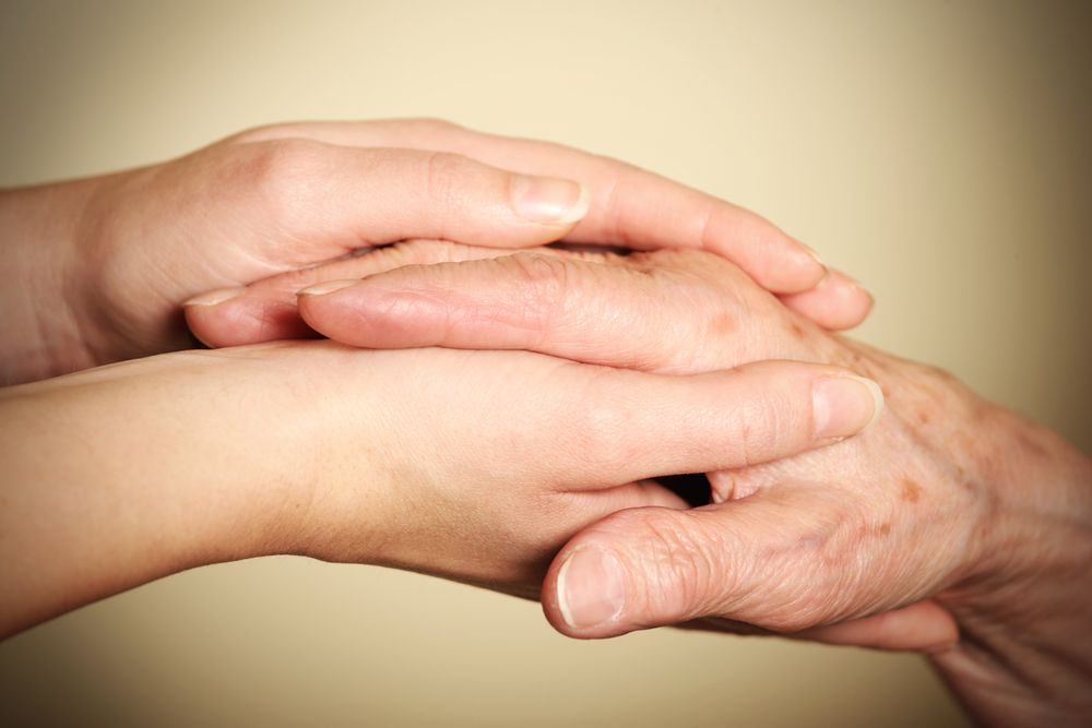 A picture of old and young hands symbolizing help and love